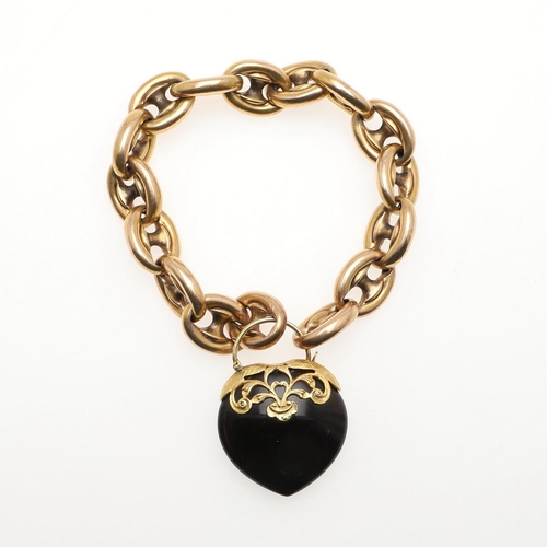 821 - A GOLD FANCY LINK BRACELET. the heart-shaped black onyx clasp with applied gold decoration, 23.0cm l... 