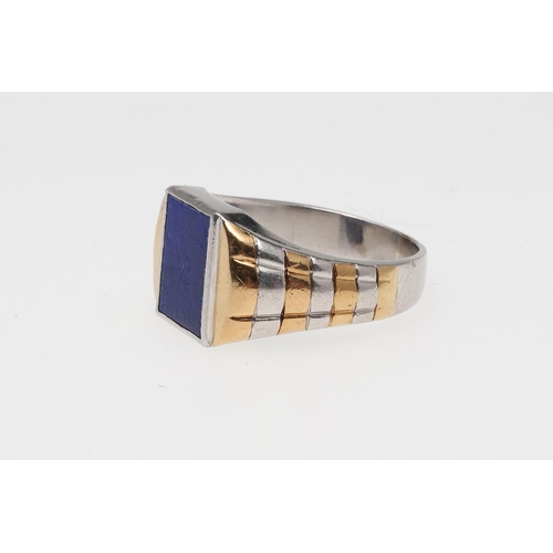 849 - A GENTLEMAN'S 1920'S PLATINUM AND GOLD LAPIS LAZULI SIGNET RING. mounted with a panel of lapis lazul... 