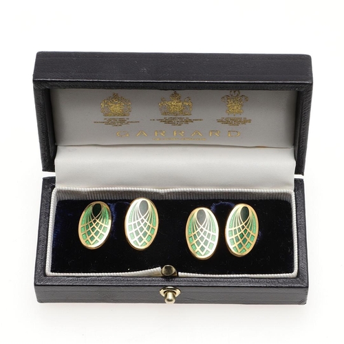 855 - A PAIR OF ENAMEL AND 18CT GOLD CUFFLINKS. of oval shape, each link with green enamel and gold decora... 