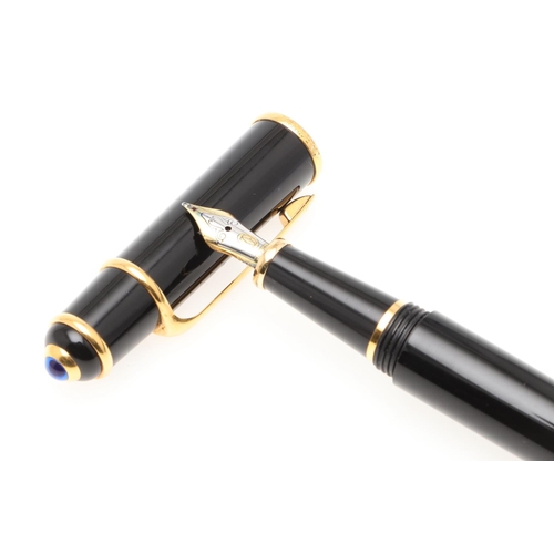 859 - A BLACK FOUNTAIN PEN BY CARTIER. with gold plated decoration, 18ct gold nip, in a red leather box by... 