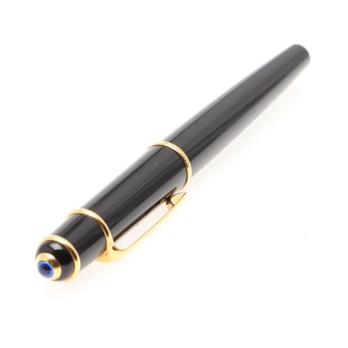 859 - A BLACK FOUNTAIN PEN BY CARTIER. with gold plated decoration, 18ct gold nip, in a red leather box by... 