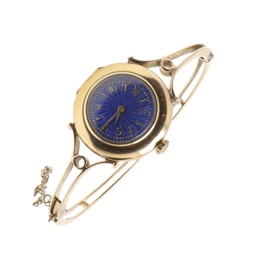 881 - A VICTORIAN GOLD AND ENAMEL BANGLE WATCH. the blue guilloche enamel dial with Arabic numerals, mount... 