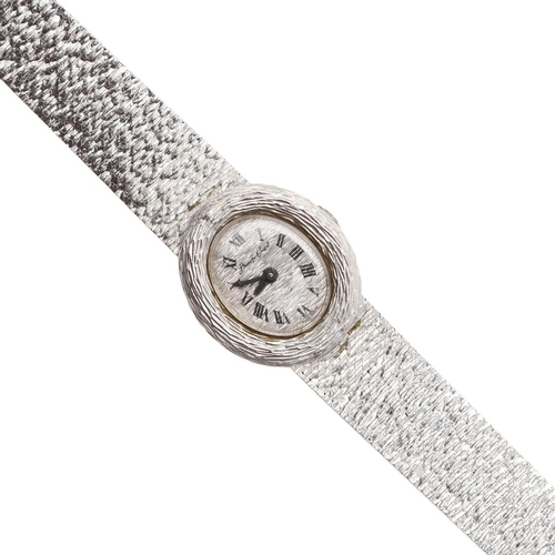 887 - A LADY'S 18CT WHITE GOLD WRISTWATCH BY BUECHE-GIROD. the signed oval-shaped textured white gold dial... 