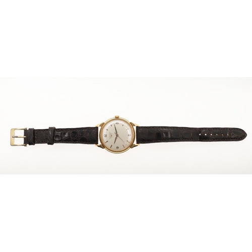 898 - A GENTLEMAN'S GOLD WRISTWATCH BY LONGINES. the signed circular dial with Arabic quarters and baton n... 