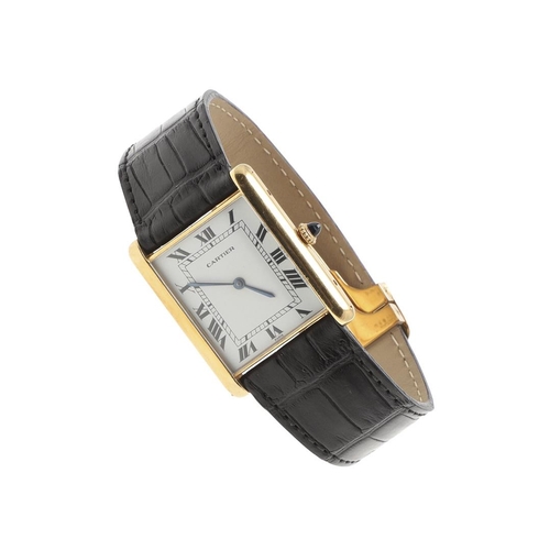 900 - AN 18CT GOLD TANK WRISTWATCH BY CARTIER. the signed white enamel dial with Roman numerals, cabochon ... 