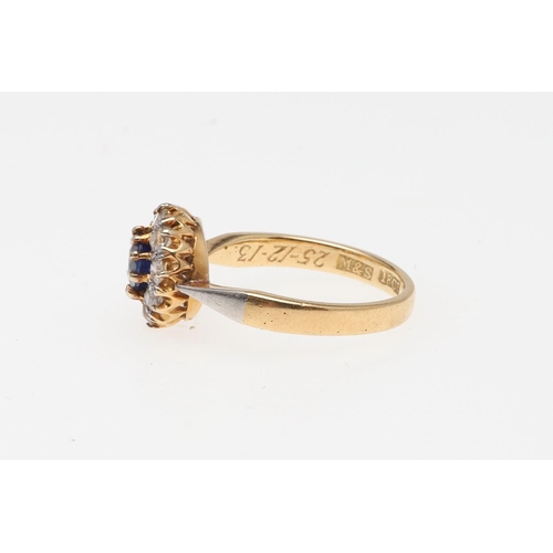 907 - A SAPPHIRE AND DIAMOND SET CLUSTER RING. the circular-cut sapphire is set within a surround of circu... 