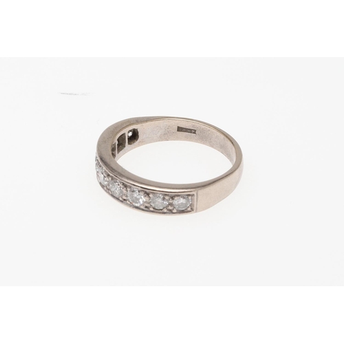 910 - A DIAMOND HALF HOOP RING. mounted with nine circular-cut diamonds, in 18ct white gold, 5.6 grams. Si... 