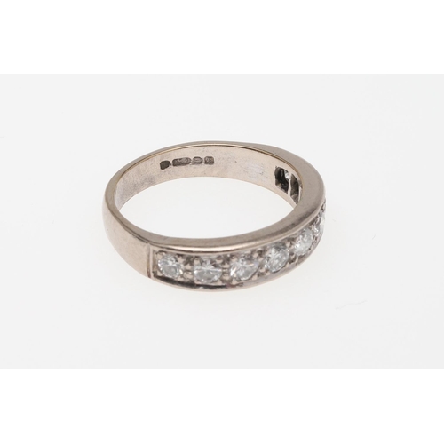 910 - A DIAMOND HALF HOOP RING. mounted with nine circular-cut diamonds, in 18ct white gold, 5.6 grams. Si... 