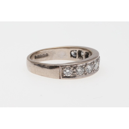 910 - A DIAMOND HALF HOOP RING. mounted with nine circular-cut diamonds, in 18ct white gold, 5.6 grams. Si... 