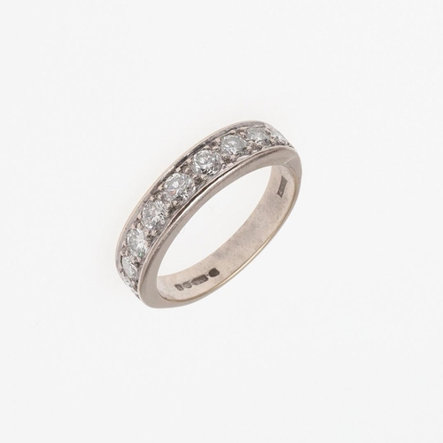 910 - A DIAMOND HALF HOOP RING. mounted with nine circular-cut diamonds, in 18ct white gold, 5.6 grams. Si... 