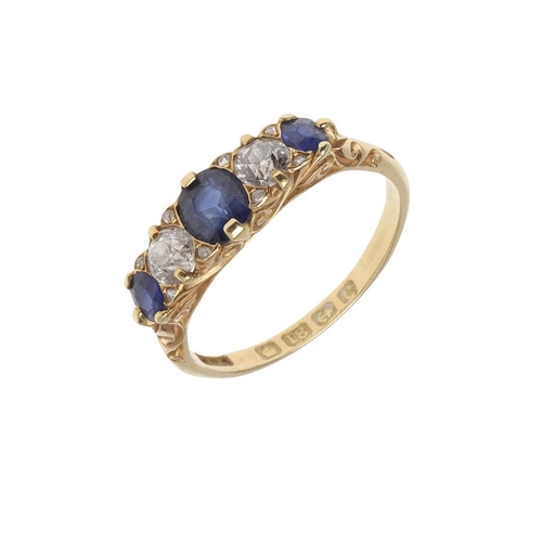 911 - A SAPPHIRE AND DIAMOND FIVE STONE RING. the three graduated oval-shaped sapphires are set with two c... 