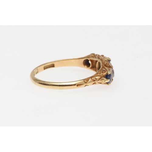 911 - A SAPPHIRE AND DIAMOND FIVE STONE RING. the three graduated oval-shaped sapphires are set with two c... 