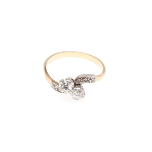 913 - A DIAMOND TWO STONE CROSS-OVER RING. set with two circular-cut diamonds, with further diamonds set t... 