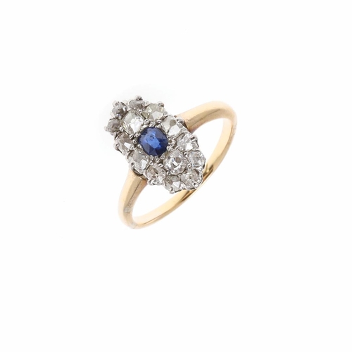 914 - A SAPPHIRE AND DIAMOND NAVETTE-SHAPED CLUSTER RING. centred with an oval-shaped sapphire within a su... 