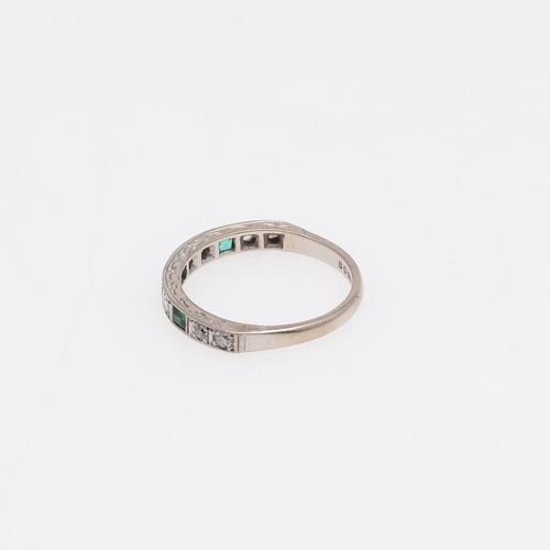 915 - AN EMERALD AND DIAMOND HALF HOOP RING. mounted with three rectangular-shaped emeralds and eight circ... 