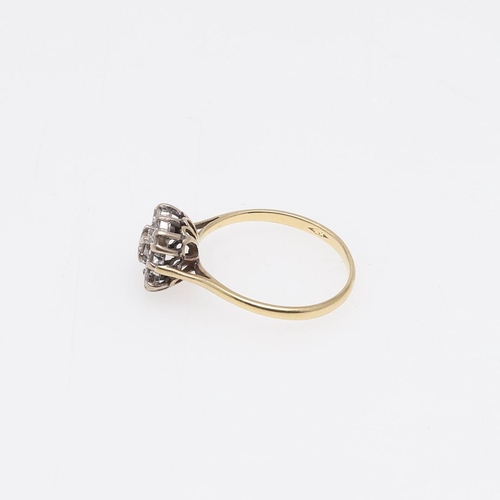 923 - A DIAMOND RING. mounted with nine circular-cut diamonds, in 18ct gold, 2.3 grams. Size M.