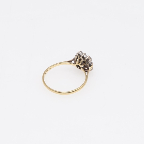 923 - A DIAMOND RING. mounted with nine circular-cut diamonds, in 18ct gold, 2.3 grams. Size M.