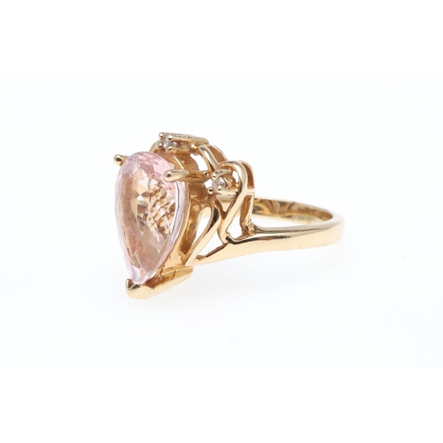 925 - A MORGANITE AND DIAMOND RING. set with a pear-shaped morganite weighing 4.40 carats, with three circ... 