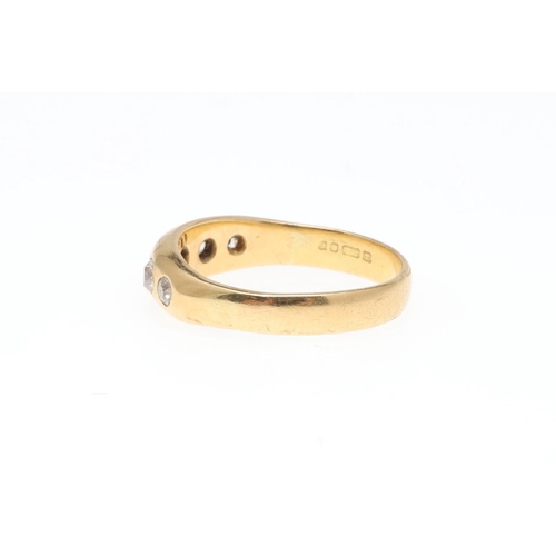 926 - AN 18CT GOLD AND DIAMOND GYPSY RING. mounted with graduated circular old-cut diamonds, 4.4 grams. Si... 