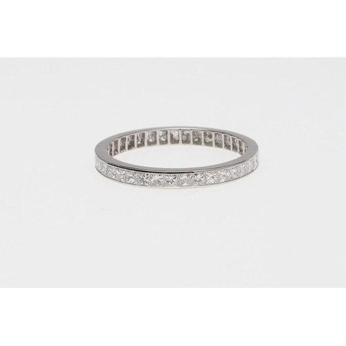 934 - A DIAMOND FULL CIRCLE ETERNITY RING. mounted with princess-cut diamonds weighing 1.05 carats in tota... 