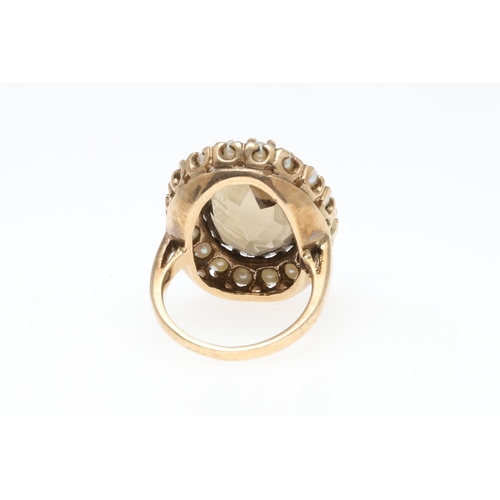 936 - A CITRINE AND PEARL CLUSTER RING. the oval-shaped citrine is set within a surround of small pearls, ... 