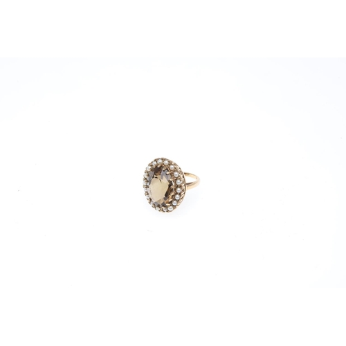 936 - A CITRINE AND PEARL CLUSTER RING. the oval-shaped citrine is set within a surround of small pearls, ... 