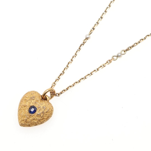 944 - A GOLD AND SAPPHIRE HEART-SHAPED LOCKET PENDANT. the locket of textured design is centred with an ov... 