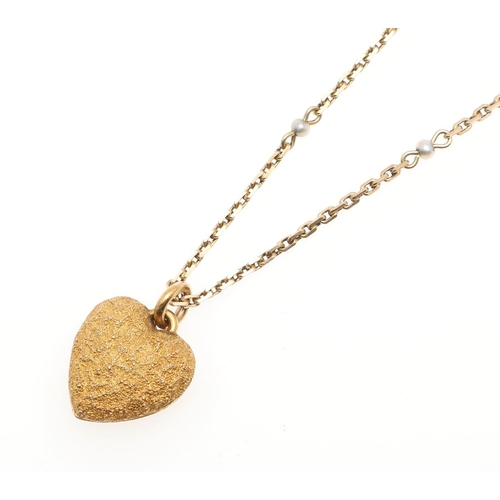 944 - A GOLD AND SAPPHIRE HEART-SHAPED LOCKET PENDANT. the locket of textured design is centred with an ov... 