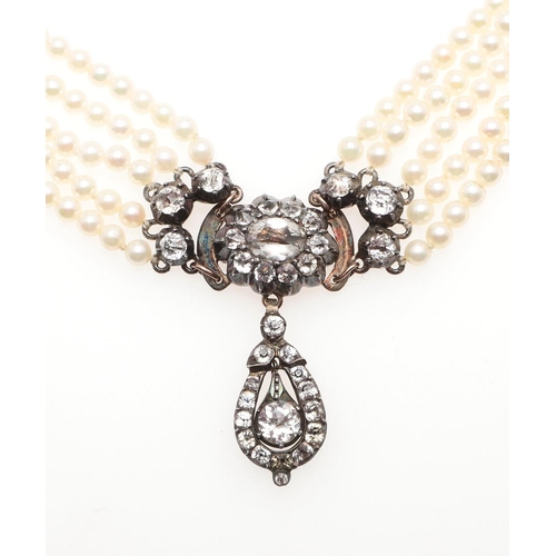 955 - A FIVE ROW CULTURED PEARL AND PASTE SET CHOKER. the cultured pearls measure approximately 3.5mm and ... 