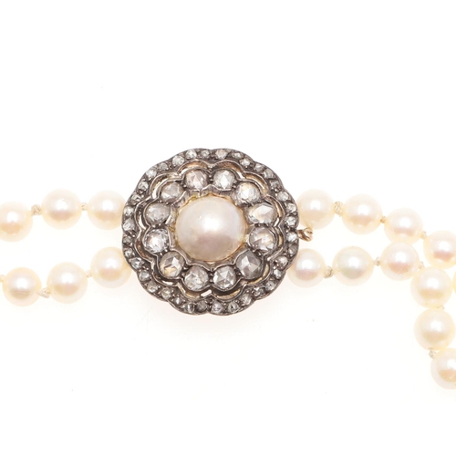 956 - A TWO ROW CULTURED PEARL AND DIAMOND CHOKER NECKLACE. the pearls measure approximately 6.0mm and are... 