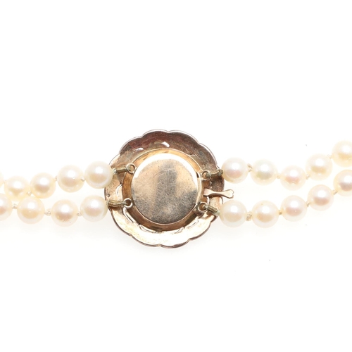 956 - A TWO ROW CULTURED PEARL AND DIAMOND CHOKER NECKLACE. the pearls measure approximately 6.0mm and are... 