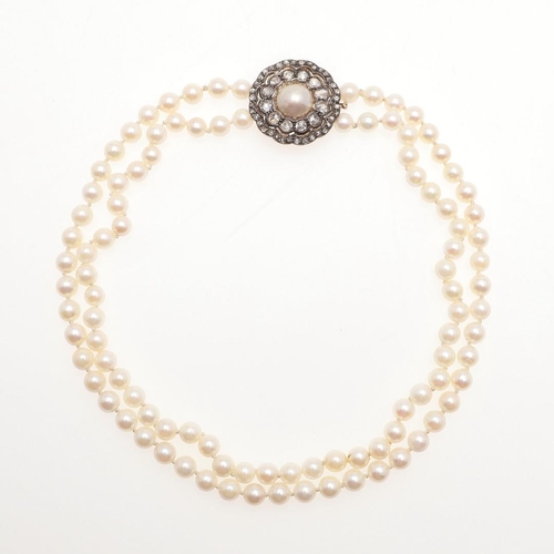 956 - A TWO ROW CULTURED PEARL AND DIAMOND CHOKER NECKLACE. the pearls measure approximately 6.0mm and are... 