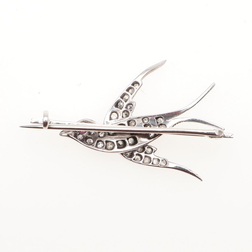 962 - A DIAMOND SET SWALLOW BROOCH. mounted overall with old-cut diamonds, with ruby eye, 4.0cm wide, 4.0 ... 