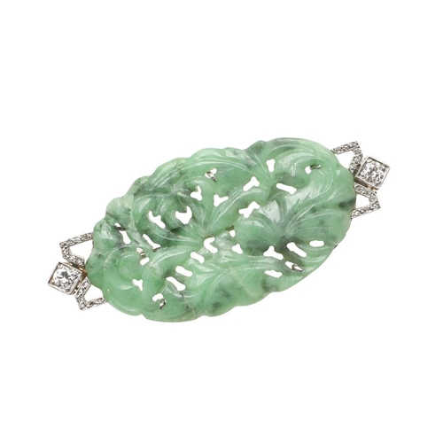 968 - AN ART DECO JADE AND DIAMOND BROOCH. mounted with an oval section of foliate carved and pierced jade... 