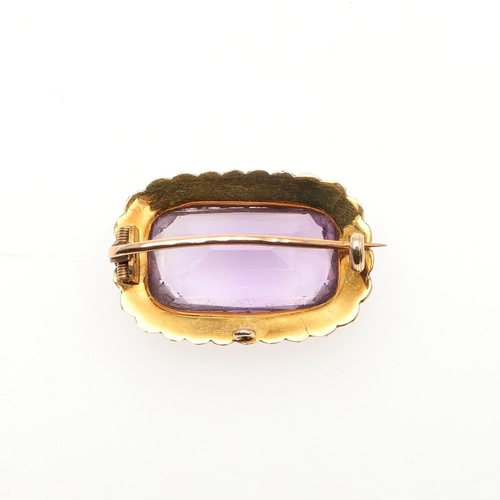 969 - AN AMETHYST AND PEARL BROOCH. the rectangular-shaped amethyst is set within a surround of half pearl... 