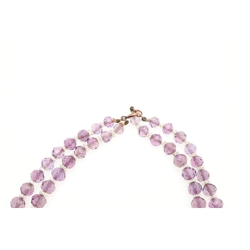 970 - AN AMETHYST NECKLACE. mounted with graduated oval-shaped amethyst drops in gilt metal, 35.5cm long, ... 