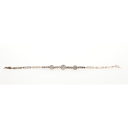 978 - A DIAMOND AND GOLD BRACELET. mounted with circular-cut diamonds in collet settings, on a 14ct gold f... 