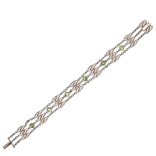 980 - A PERIDOT, PEARL AND GOLD BRACELET. the fancy link 9ct gold bracelet mounted with circular-cut perid... 