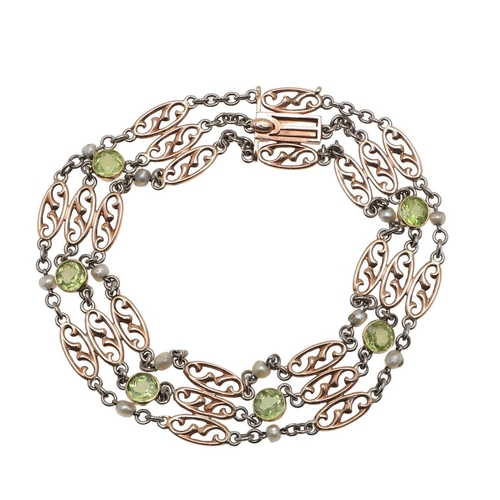 980 - A PERIDOT, PEARL AND GOLD BRACELET. the fancy link 9ct gold bracelet mounted with circular-cut perid... 