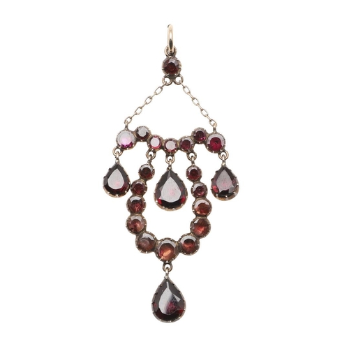 982 - A GEORGIAN GARNET AND GOLD PENDANT. mounted with four pear-shaped garnet drops and overall with circ... 