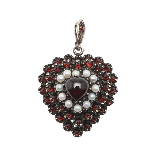 984 - A VICTORIAN HEART-SHAPED GARNET AND PEARL PENDANT. centred with a cabochon garnet, within a triple s... 