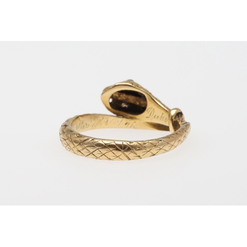 988 - A VICTORIAN 18CT GOLD SNAKE RING. with engraved decoration and with rose-cut diamond set eyes, indis... 