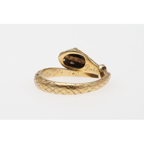 988 - A VICTORIAN 18CT GOLD SNAKE RING. with engraved decoration and with rose-cut diamond set eyes, indis... 