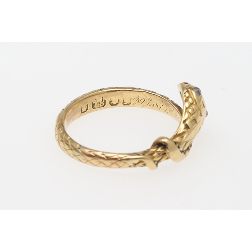 988 - A VICTORIAN 18CT GOLD SNAKE RING. with engraved decoration and with rose-cut diamond set eyes, indis... 