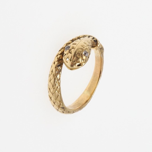 988 - A VICTORIAN 18CT GOLD SNAKE RING. with engraved decoration and with rose-cut diamond set eyes, indis... 