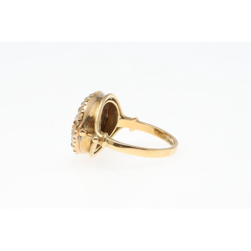 989 - A CITRINE AND PEARL CLUSTER RING. the oval- shaped citrine is set within a surround of half pearls, ... 