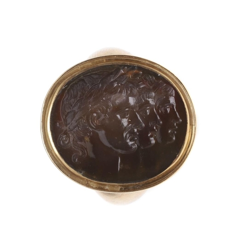 997 - AN 18TH CENTURY HARDSTONE INTAGLIO RING. depicting the profiles of three Roman Emperors, in a gold m... 