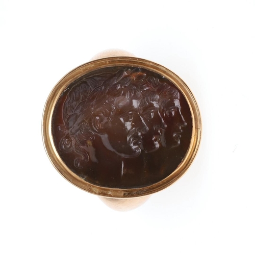 997 - AN 18TH CENTURY HARDSTONE INTAGLIO RING. depicting the profiles of three Roman Emperors, in a gold m... 