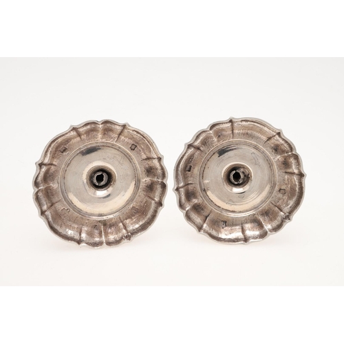 147 - A PAIR OF GEORGE II CAST SILVER CANDLESTICKS. on shaped circular bases, with knopped stems and spool... 