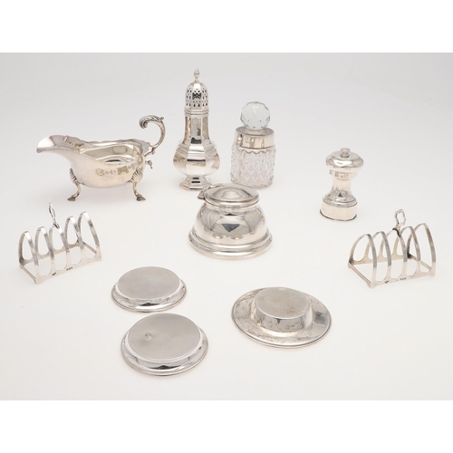 158 - A SMALL MIXED LOT OF SILVER. to include a pair of toast racks, an inkwell (loaded base), a sauce boa... 